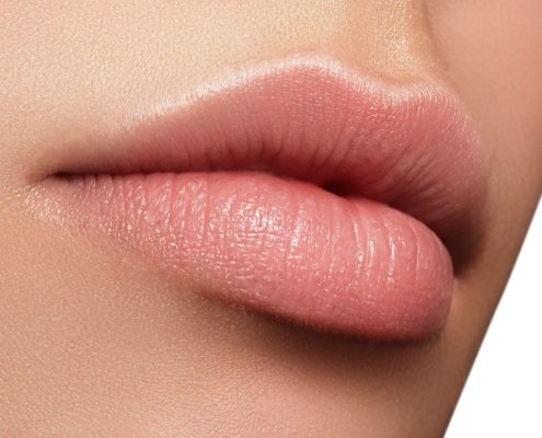 Perfect natural lip makeup. Close up macro photo with beautiful female mouth. Plump full lips. Close-up face detail. Perfect clean skin, light fresh lip make-up. Beautiful spa tender lip