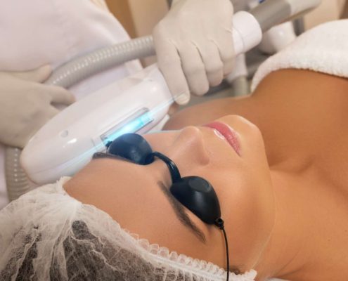 Beautiful woman in beauty salon during photo rejuvenation procedure